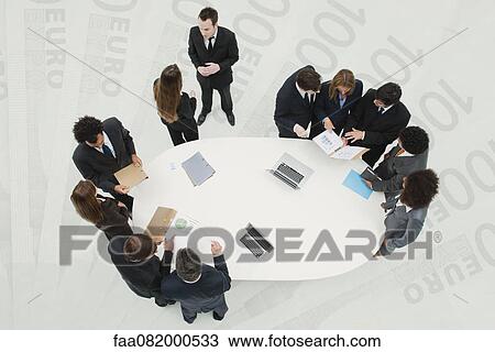 Business associates in meeting, standing on superimposed image of one-hundred Euro banknotes View Large Photo Image Stock Image - Business associates in meeting, standing on superimposed image of one-hundred Euro banknotes. Fotosearch