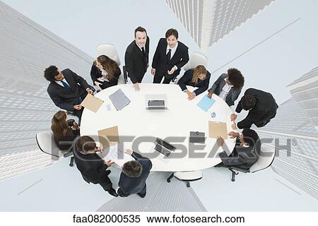 Business executives meeting on top of superimposed image of skyscrapers View Large Photo Image Stock Photography - Business executives meeting on top of superimposed image of skyscrapers. Fotosearch