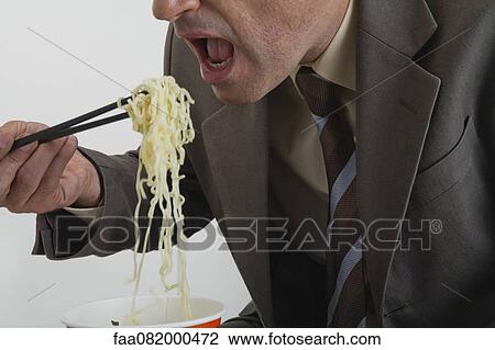 Businessman eating ramen noodles View Large Photo Image Stock Image - Businessman eating ramen noodles. Fotosearch