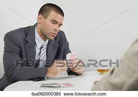 Stock Photography - Businessman playing cards. Fotosearch
