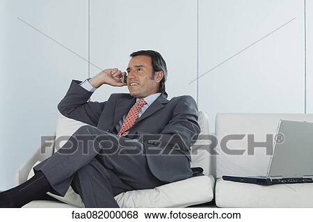 Businessman talking on cell phone View Large Photo Image Stock Photo - Businessman talking on cell phone. Fotosearch