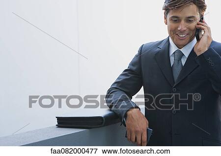 Businessman talking on cell phone View Large Photo Image Stock Photo - Businessman talking on cell phone. Fotosearch