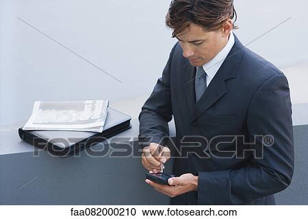 Businessman using PDA View Large Photo Image Stock Image - Businessman using PDA. Fotosearch