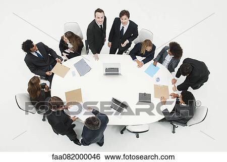 Businessman working with associates at working meeting View Large Photo Image Stock Photograph - Businessman working with associates at working meeting. Fotosearch