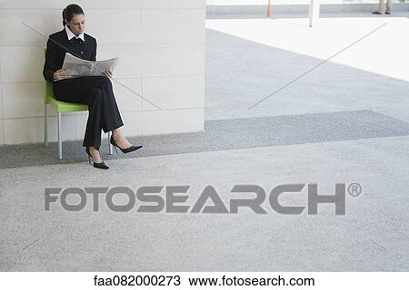 Businesswoman reading newspaper outdoors View Large Photo Image Stock Image - Businesswoman reading newspaper outdoors. Fotosearch