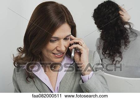 Businesswoman talking on cell phone View Large Photo Image Stock Image - Businesswoman talking on cell phone. Fotosearch