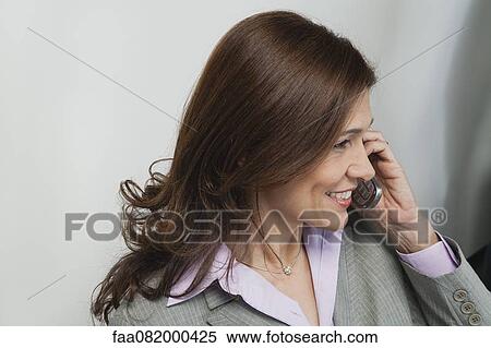 Stock Photography - Businesswoman talking on cell phone. Fotosearch