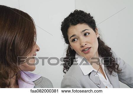 Businesswoman talking with colleague View Large Photo Image Stock Image - Businesswoman talking with colleague. Fotosearch