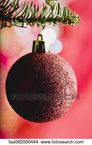 Picture - Christmas bauble hanging on branch. Fotosearch