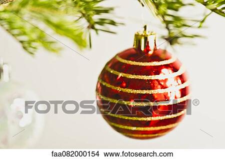 Christmas baubles hanging from Christmas tree, out of focus View Large Photo Image Picture - Christmas baubles hanging from Christmas tree, out of focus. Fotosearch
