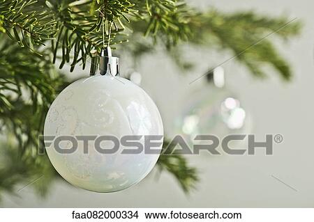 Picture - Christmas baubles hanging from Christmas tree, close-up. Fotosearch