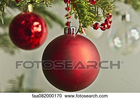Stock Image - Christmas baubles hanging from Christmas tree. Fotosearch
