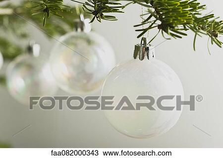 Christmas baubles hanging from Christmas tree View Large Photo Image Stock Image - Christmas baubles hanging from Christmas tree. Fotosearch