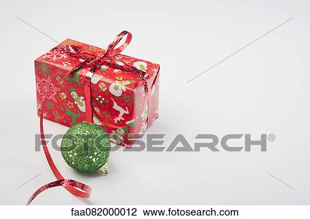 Christmas ornament and festively wrapped present View Large Photo Image Stock Image - Christmas ornament and festively wrapped present. Fotosearch