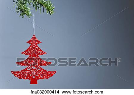 Christmas tree ornament hanging on branch, off center View Large Photo Image Picture - Christmas tree ornament hanging on branch, off center. Fotosearch