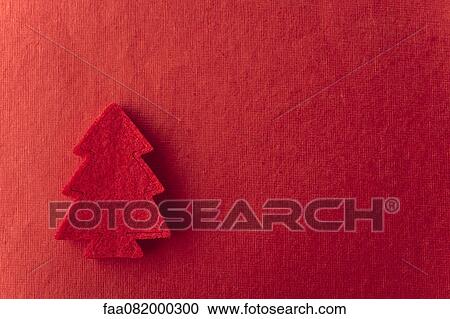 Stock Image - Christmas tree shape on red background. Fotosearch