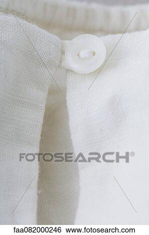 Close-up of button closure on clothing View Large Photo Image Stock Photograph - Close-up of button closure on clothing. Fotosearch