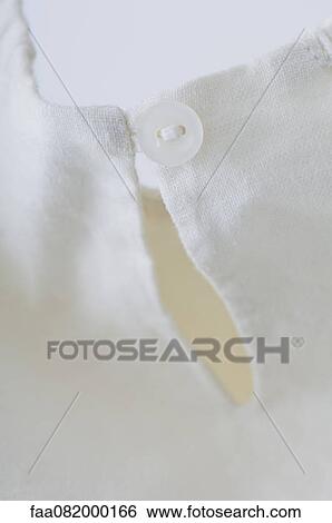 Close-up of button closure on garment View Large Photo Image Stock Photograph - Close-up of button closure on garment. Fotosearch