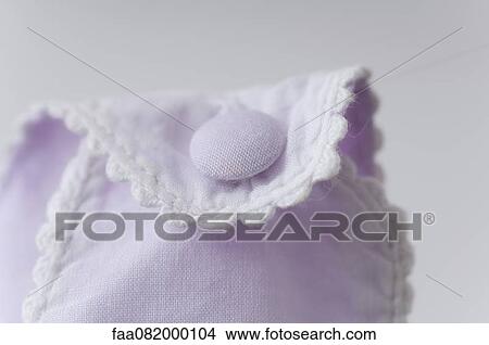 Close-up of button on baby clothing View Large Photo Image Picture - Close-up of button on baby clothing. Fotosearch