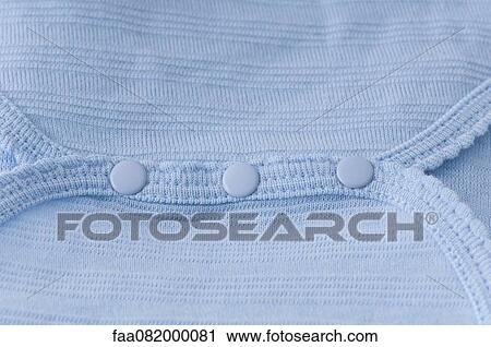 Stock Image - Close-up of snaps on baby clothing, close-up. Fotosearch