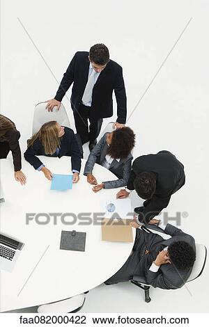 Stock Image - Colleagues collaborating on project. Fotosearch