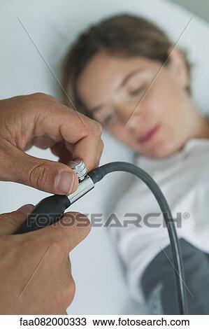 Doctor checking female patient's blood pressure, cropped View Large Photo Image Stock Image - Doctor checking female patient's blood pressure, cropped. Fotosearch