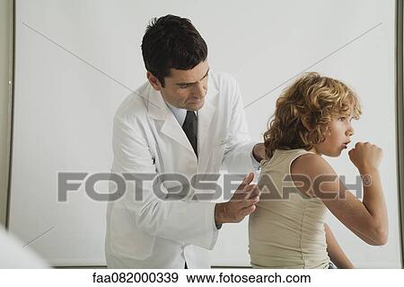 Stock Photo - Doctor checking young patient's cough. Fotosearch