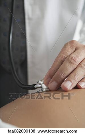 Doctor examining pregnant woman, cropped View Large Photo Image Stock Photo - Doctor examining pregnant woman, cropped. Fotosearch