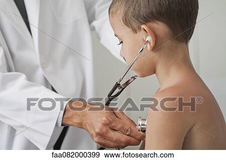 Stock Photo - Doctor letting boy listen to own chest with stethoscope. Fotosearch