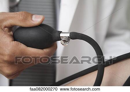 Doctor squeezing bulb on blood pressure gauge, cropped View Large Photo Image Stock Image - Doctor squeezing bulb on blood pressure gauge, cropped. Fotosearch