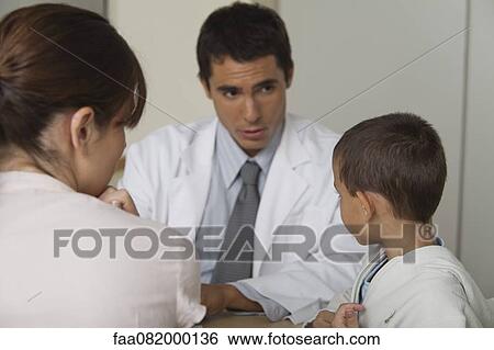 Stock Photograph - Doctor talking with little boy and woman. Fotosearch