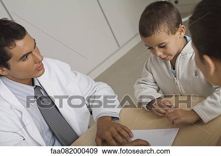 Stock Photo - Doctor with little boy and woman. Fotosearch