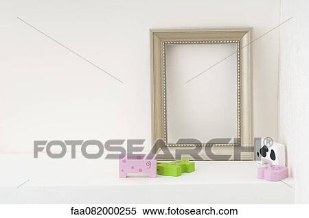 Empty picture frame and child's toys on shelf View Large Photo Image Stock Photography - Empty picture frame and child's toys on shelf. Fotosearch