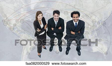 Stock Photo - Executives standing on world map. Fotosearch