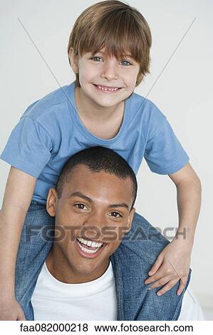 Father carrying son on shoulders, portrait View Large Photo Image Stock Photo - Father carrying son on shoulders, portrait. Fotosearch