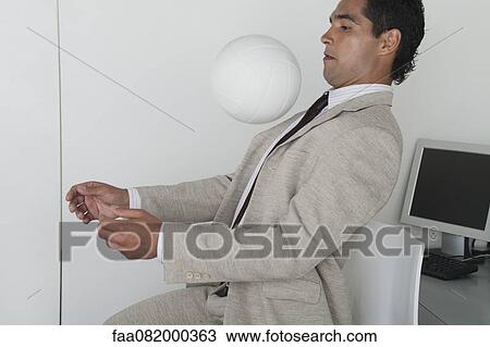 Man playing with ball in office View Large Photo Image Stock Image - Man playing with ball in office. Fotosearch