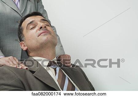 Picture - Mature businessman having shoulders massaged. Fotosearch