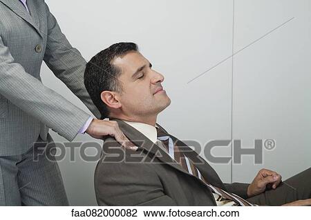 Mature businessman having shoulders massaged View Large Photo Image Stock Image - Mature businessman having shoulders massaged. Fotosearch