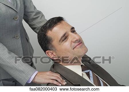 Mature businessman having shoulders massaged View Large Photo Image Stock Image - Mature businessman having shoulders massaged. Fotosearch