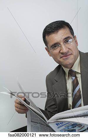 Mature businessman reading newspaper, portrait View Large Photo Image Stock Image - Mature businessman reading newspaper, portrait. Fotosearch