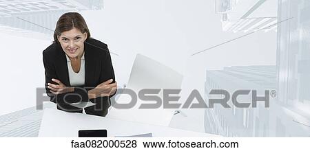Stock Photo - Mature businesswoman smiling confidently with skyscrapers superimposed on background. Fotosearch
