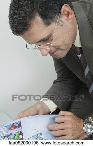 Mature man reading comic book View Large Photo Image Stock Photograph - Mature man reading comic book. Fotosearch
