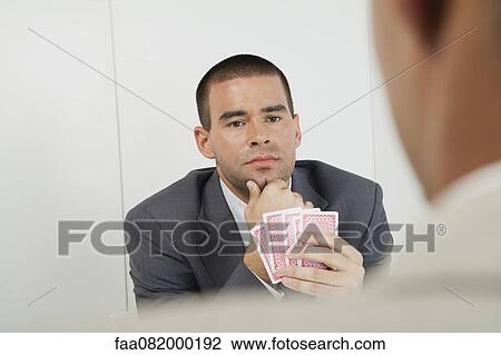 Stock Image - Men playing cards. Fotosearch