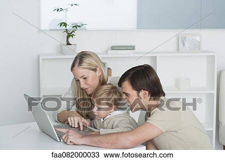Parents and little boy using laptop computer together View Large Photo Image Stock Image - Parents and little boy using laptop computer together. Fotosearch