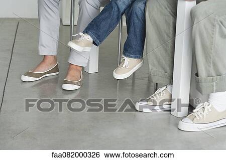 Parents sitting with child, low section View Large Photo Image Stock Photograph - Parents sitting with child, low section. Fotosearch