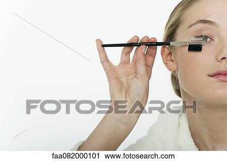 Preteen girl brushing her eyelashes, cropped View Large Photo Image Stock Image - Preteen girl brushing her eyelashes, cropped. Fotosearch