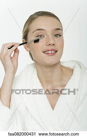 Preteen girl brushing her eyelashes View Large Photo Image Stock Image - Preteen girl brushing her eyelashes. Fotosearch