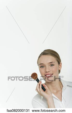 Preteen girl holding make-up brush, portrait View Large Photo Image Stock Image - Preteen girl holding make-up brush, portrait. Fotosearch