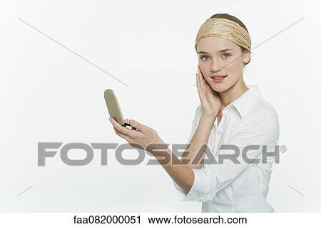 Preteen girl holding mirror compact, touching face, portrait View Large Photo Image Stock Image - Preteen girl holding mirror compact, touching face, portrait. Fotosearch