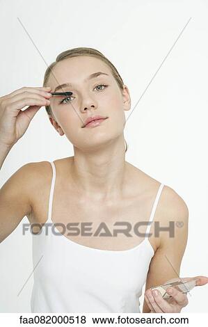Stock Photo - Preteen girl putting on eye shadow. Fotosearch